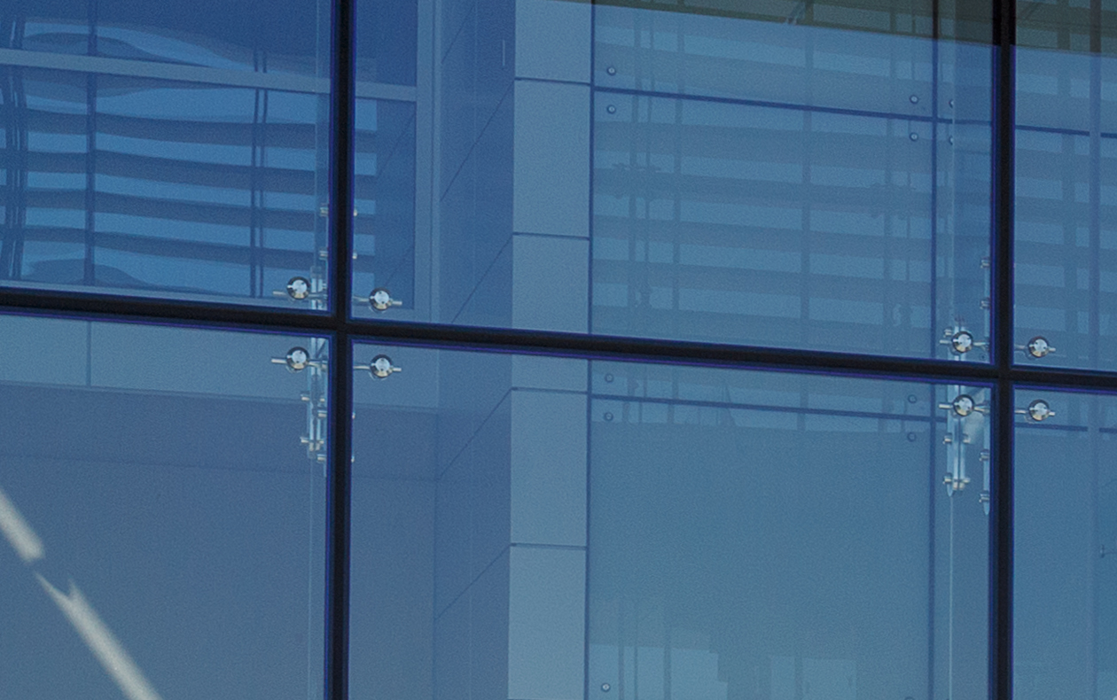 Photo of glass panes on the front of a Metro office building.