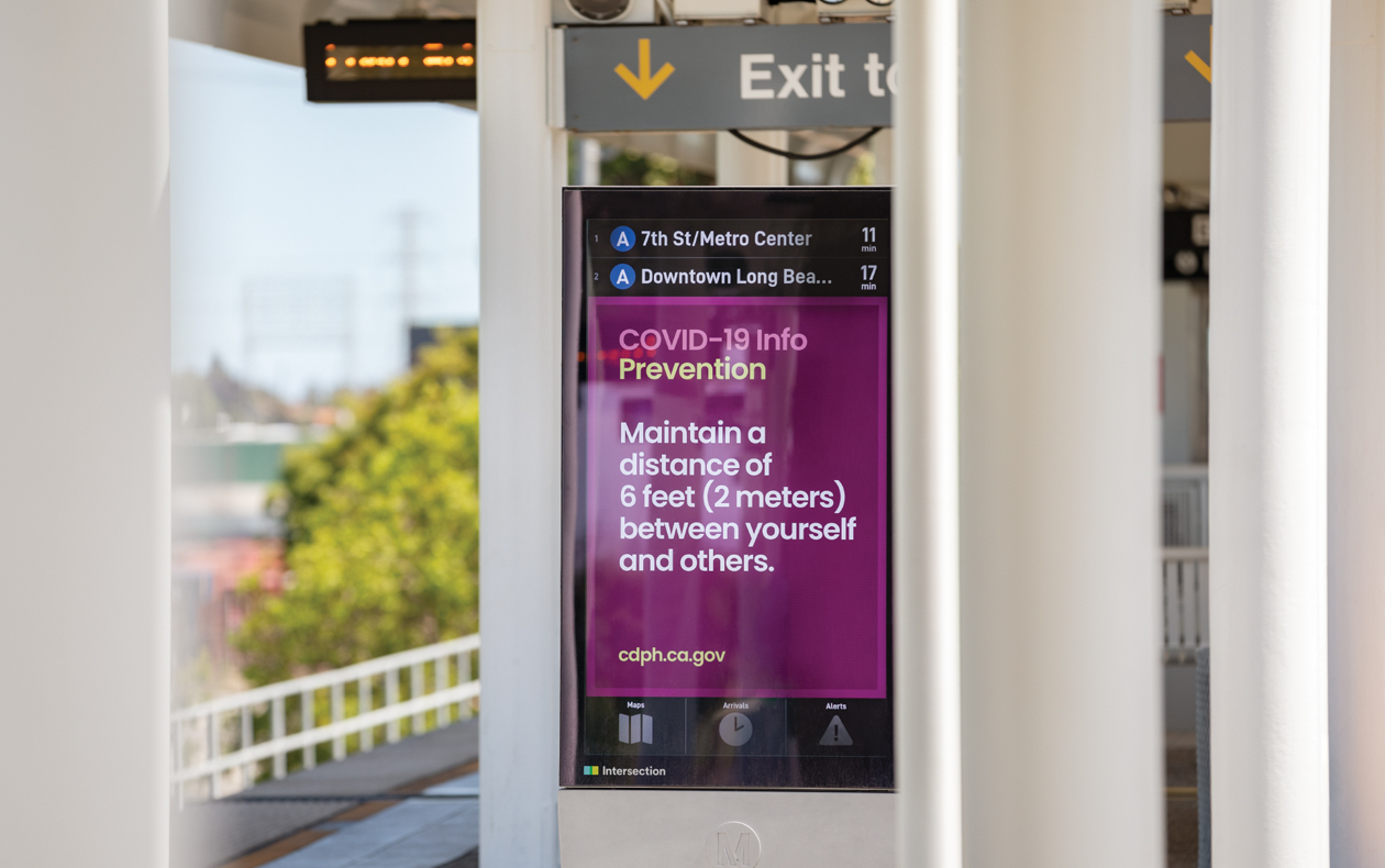 Sign at a light rail station displaying information on COVID-19 information.