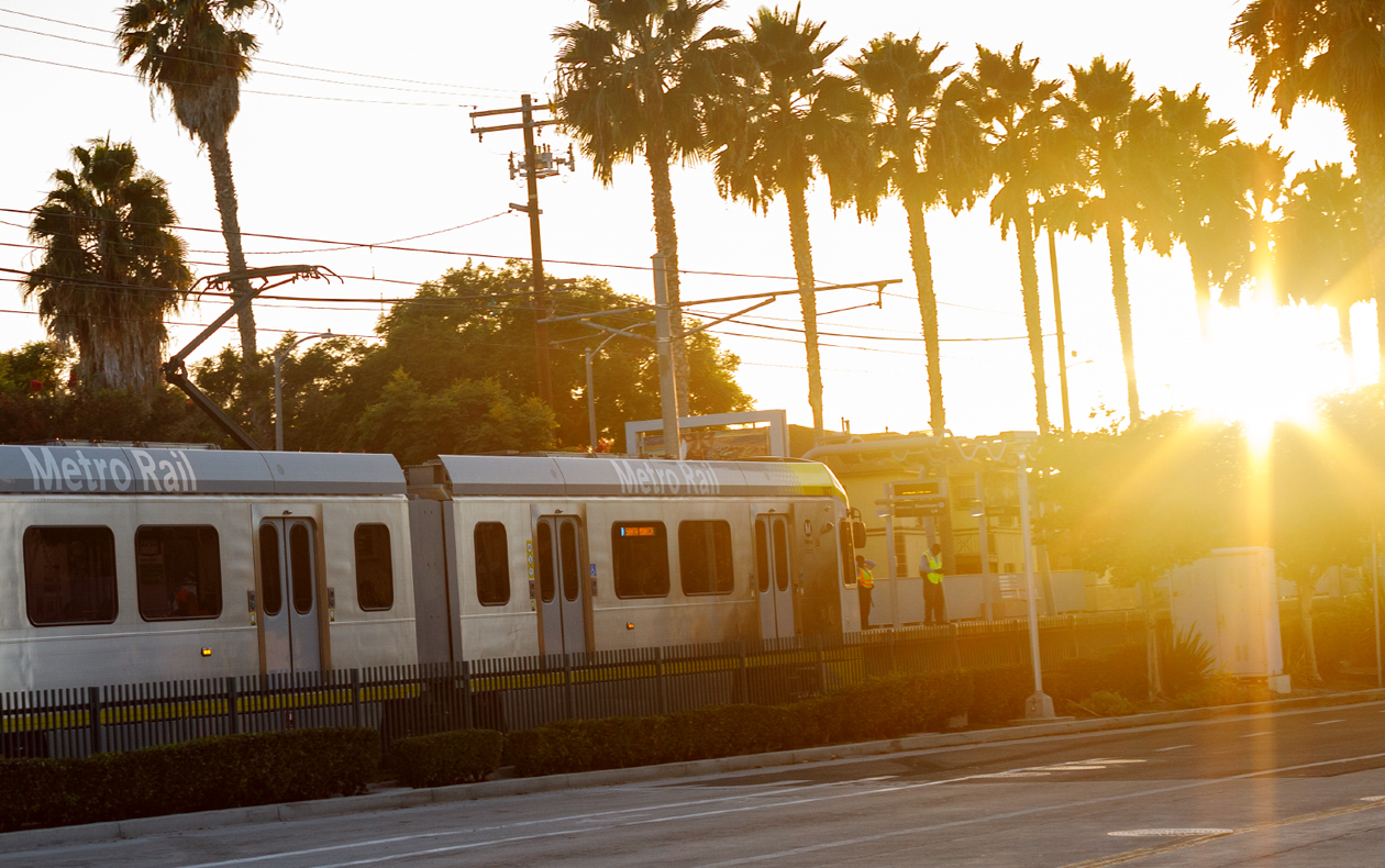Bus in motion with the bright sun reflecting off the bus.