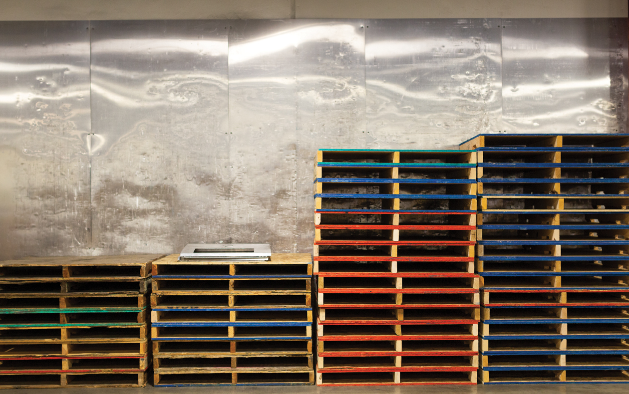 Photo of stacked reusable pallets.